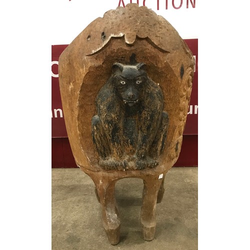 185 - An Anglo-Indian carved oak tub chair, depicting a mythical beast to back