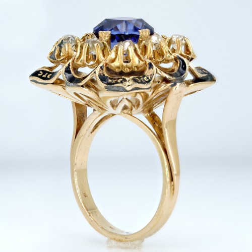 7022 - An 18ct gold 3.3ct sapphire and 0.8ct diamond ring with black enamel border, 10.5g, 1.9cm, O