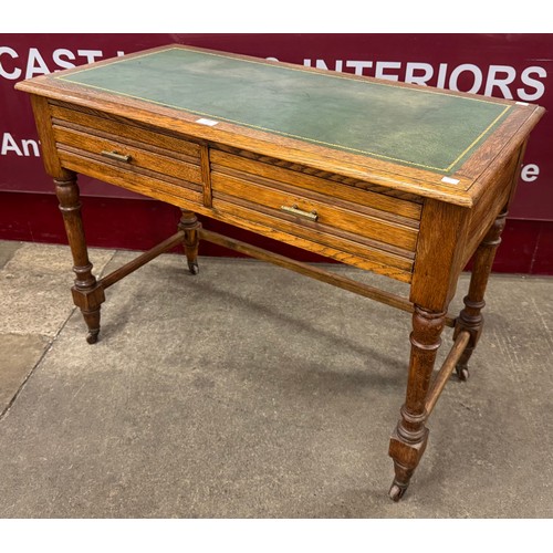 231 - A Victorian oak and green leather topped two drawer writing table