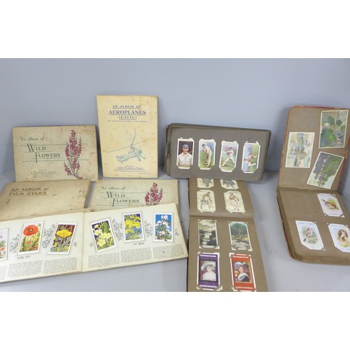 2306 - A large collection of cigarette and tea cards, loose and in albums, including Will's cricketers 1928... 