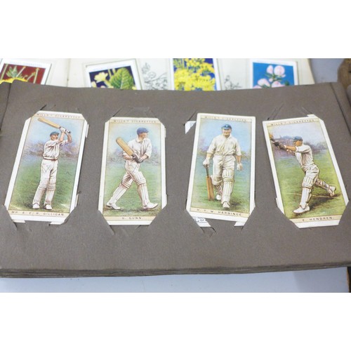 2306 - A large collection of cigarette and tea cards, loose and in albums, including Will's cricketers 1928... 