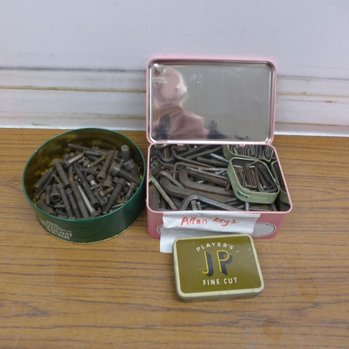 5085 - A tin of cap head machine bolts, a tin of allen keys and a tin of taps and dies