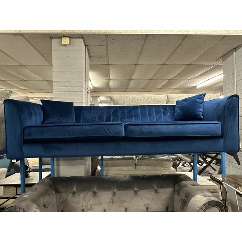 3106 - A blue velvet four seater sofa