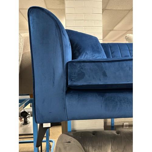 3106 - A blue velvet four seater sofa