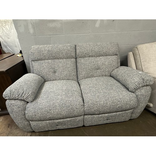 3135 - A white and blue woven two seater sofa