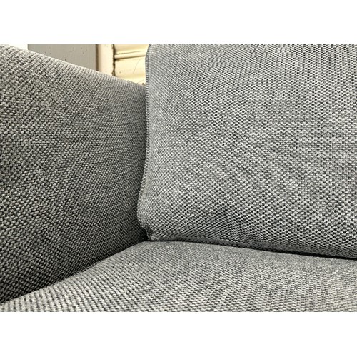 3204 - A grey woven upholstered three seater sofa