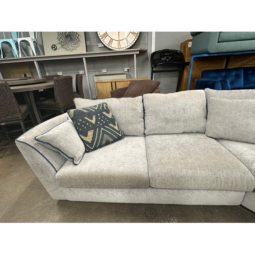 3206 - A stone grey upholstered three piece corner sofa with blue piping