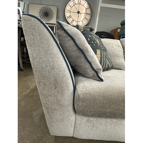 3206 - A stone grey upholstered three piece corner sofa with blue piping