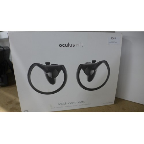 5065 - An Oculus Rift VR gaming headset and sensors with touch controllers, both boxed