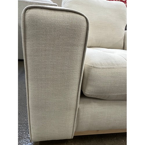 3215 - An ivory upholstered deep seating armchair with exposed wood