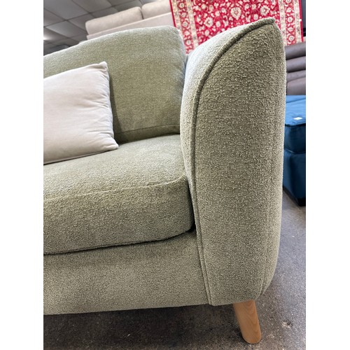 3216 - An olive boucle shell back armchair