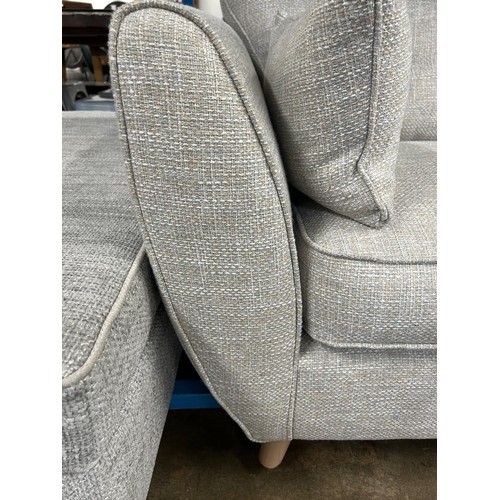 3245 - A beige upholstered button back two seater sofa