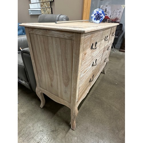 3064 - A bleached wood 7 drawer French style sideboard - (Damaged back board)