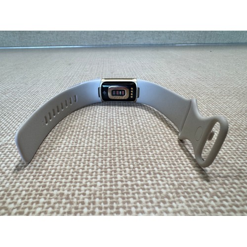 6004 - Fitbit Charge 5 activity tracker with charger and beige strap *This lot is subject VAT