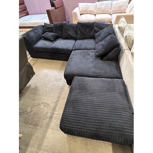 3294 - A black jumbo cord corner sofa with footstool (marked)