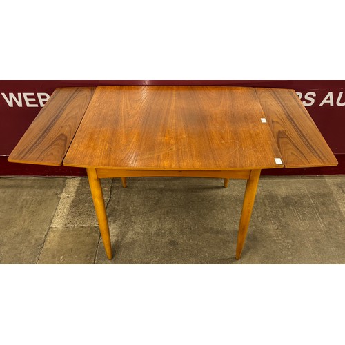 10 - A Lebus teak extending dining table and four chairs