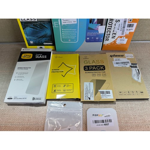 6059 - A quantity of various glass screen protectors and two pop sockets *This lot is subject to VAT