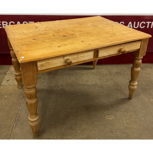 117 - A Victorian style pine farmhouse four drawer kitchen table