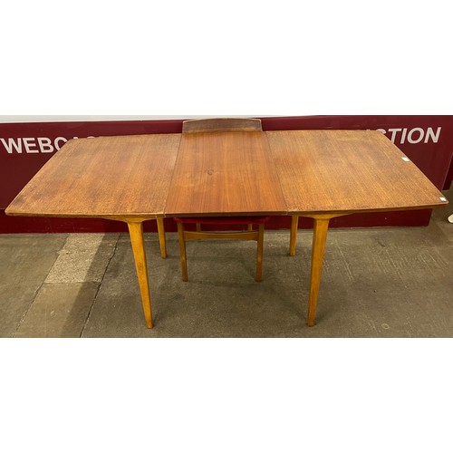 46 - A teak extending dining table and four chairs