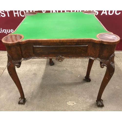 136 - A George III style figured walnut fold over games table