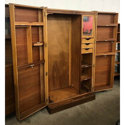 141 - An Art Deco oak fitted Compactum style two door wardrobe