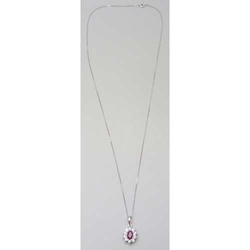 7012 - An 18ct gold ruby and diamond pendant, 0.4ct diamonds, with a 9ct white gold chain, 1.8cm pendant in... 