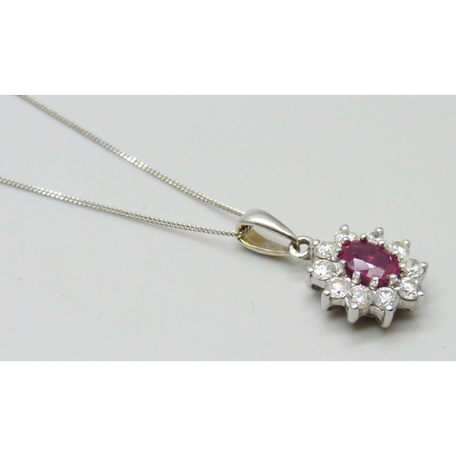 7012 - An 18ct gold ruby and diamond pendant, 0.4ct diamonds, with a 9ct white gold chain, 1.8cm pendant in... 