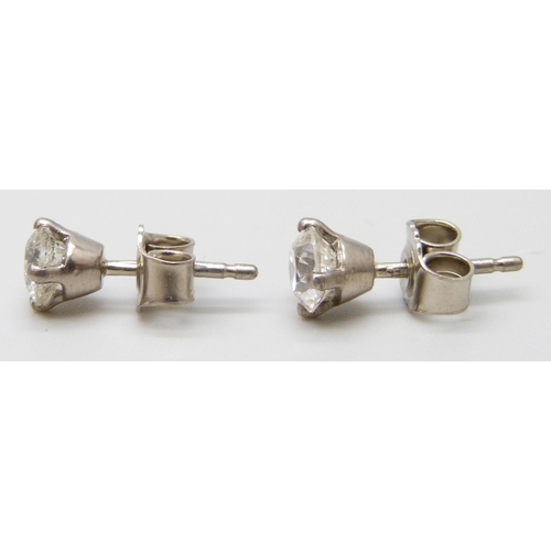 7026 - A pair of hallmarked 18ct white gold diamond stud earrings, total diamond weight 1.12ct