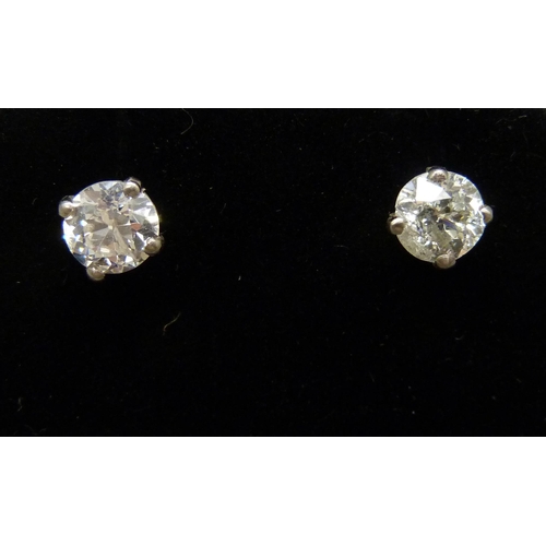 7026 - A pair of hallmarked 18ct white gold diamond stud earrings, total diamond weight 1.12ct