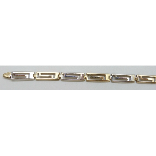 7031 - A 9ct gold two tone Greek key design bracelet, 18.3cm, 3.2g