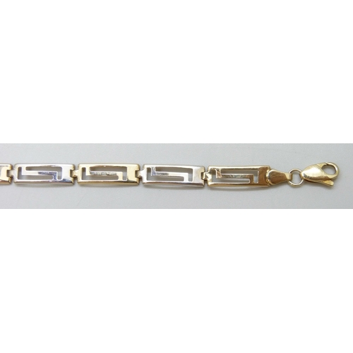 7031 - A 9ct gold two tone Greek key design bracelet, 18.3cm, 3.2g