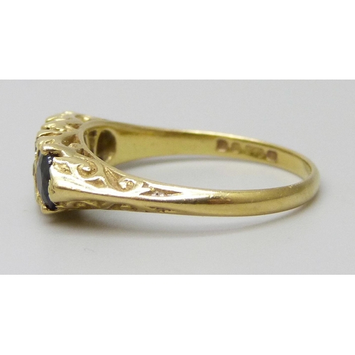 7043 - An 18ct gold, sapphire and diamond ring, 3.4g, M