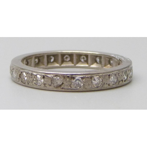 7044 - A white metal set diamond eternity ring, 3.3g, L