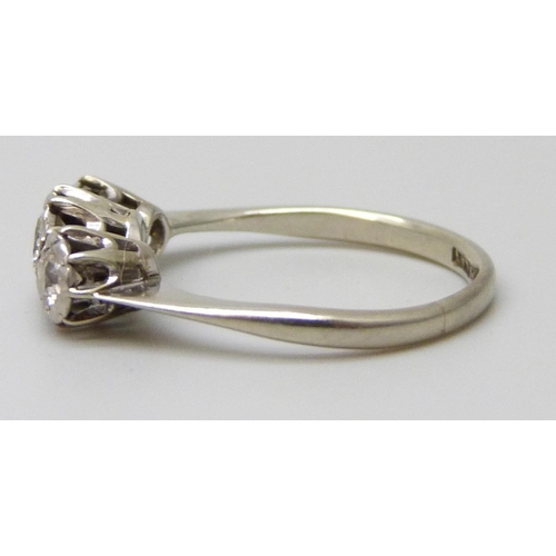 7045 - An 18ct gold and platinum three stone diamond ring, 2.2g, J