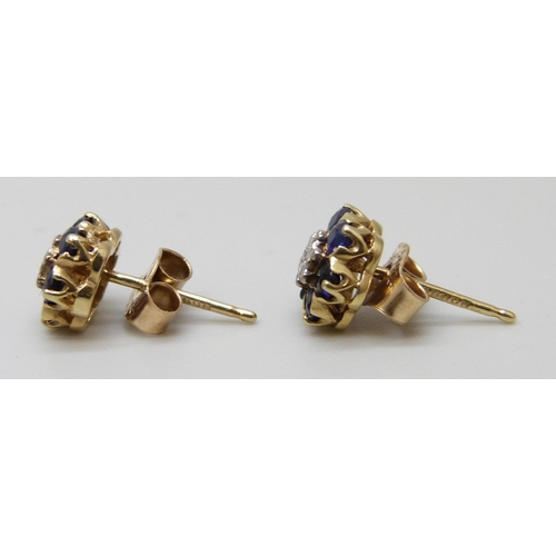 7049 - A pair of hallmarked 9ct gold cluster earrings set with a central diamond, 1.2g, 7mm