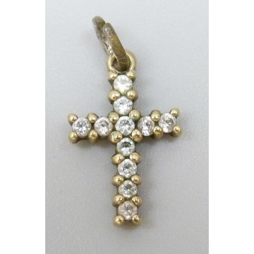 7052 - A small 9k gold cross pendant set with white stones, replacement metal bale, 0.6g total weight, 1.3c... 