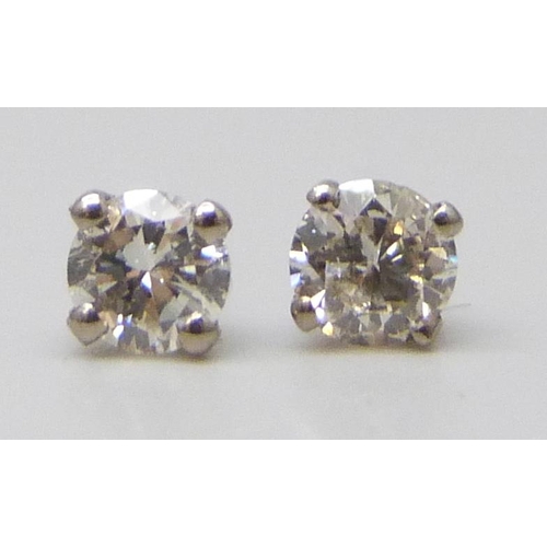 7055 - A pair of hallmarked 18ct white gold diamond stud earrings, total diamond weight 0.50ct