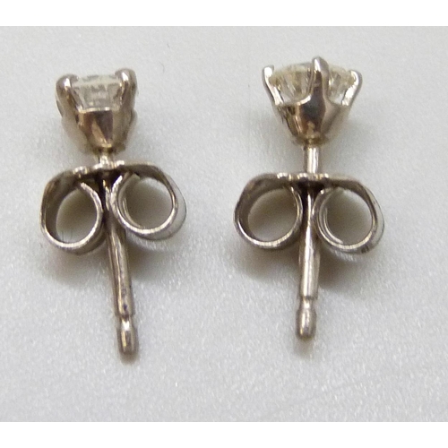 7055 - A pair of hallmarked 18ct white gold diamond stud earrings, total diamond weight 0.50ct