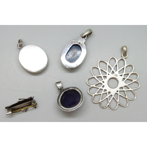 7064 - Three silver pendants, largest 5.5cm including bale, 29g, a white metal pendant, and a plated bug br... 