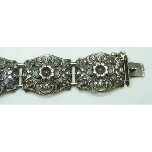 7084 - A .800 silver fretwork panel bracelet with floral decoration, 17.5cm, 29g