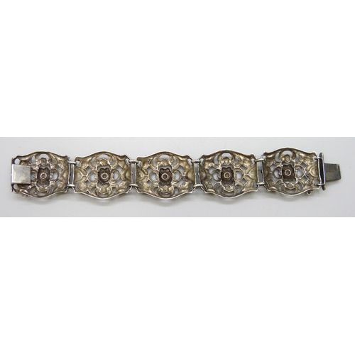 7084 - A .800 silver fretwork panel bracelet with floral decoration, 17.5cm, 29g