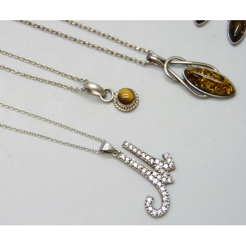 7088 - A collection of silver chains and pendants, 34g, together with a white metal pendant and a pair of s... 