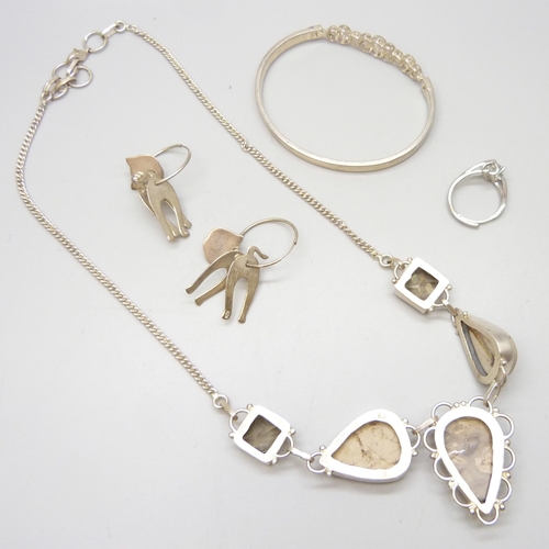 7094 - A collection of silver jewellery to include a bangle, ring, and cat earrings, 20g, together with a p... 