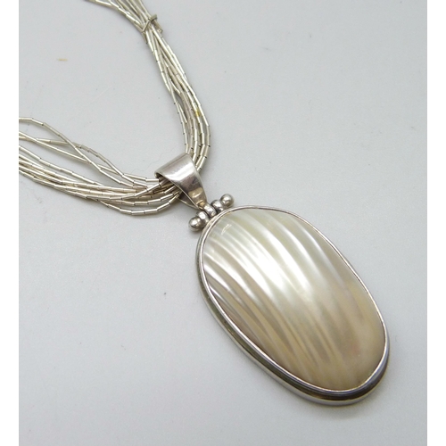 7097 - A silver and mother of pearl pendant, 5cm including bale, on a silver beaded chain, 24g total