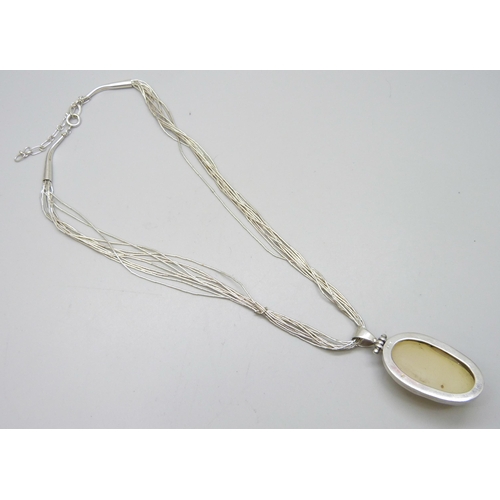 7097 - A silver and mother of pearl pendant, 5cm including bale, on a silver beaded chain, 24g total