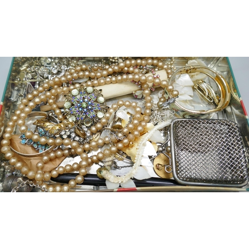 7149 - A collection of costume jewellery, a silver plated purse, etc.