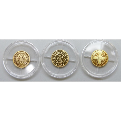 7219 - Three small 14ct gold commemorative coins, each 0.5g and marked 585