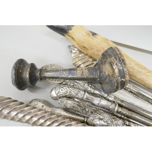 7257 - A large collection of silver topped button hooks including one in the form of a swan's head, a Willi... 