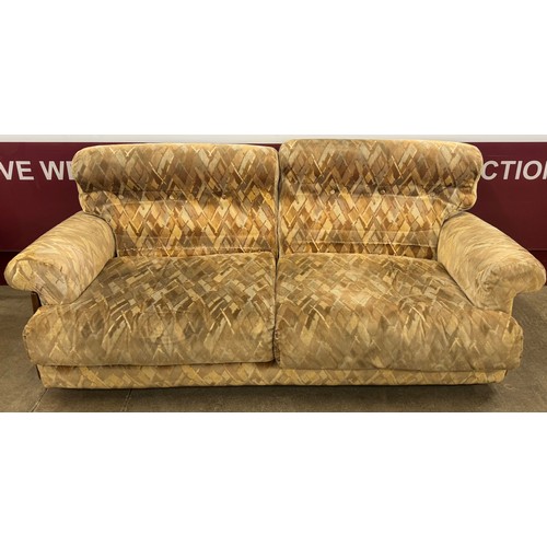 76 - A teak and fabric upholstered two piece lounge suite, comprising; two seater settee and armchair