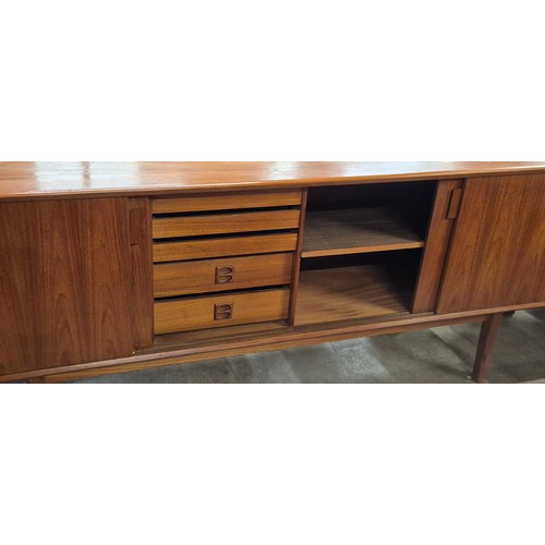 26A - A Danish teak fitted sliding four door sideboard